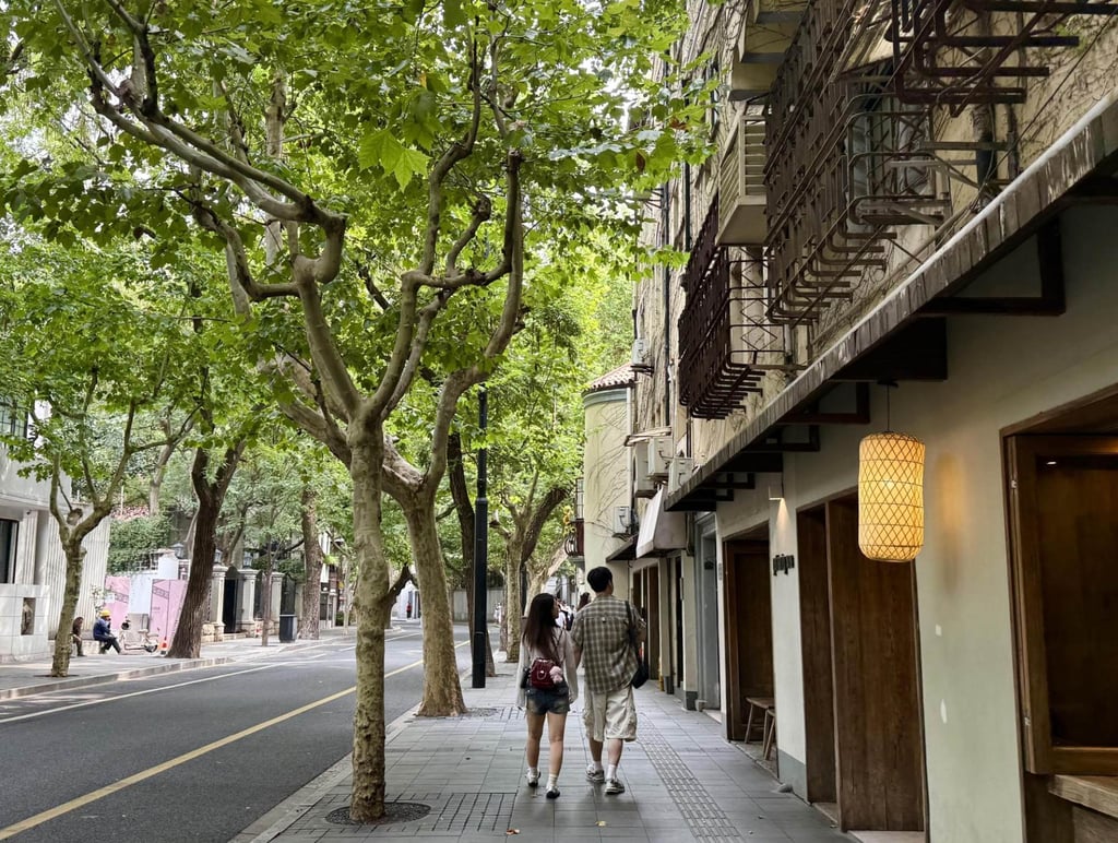 A Korean couple walks along Wukang Road in Shanghai, China. The tree-lined street features historical European-style architecture, local shops and boutique cafes. Photo: Lee Hae-rin