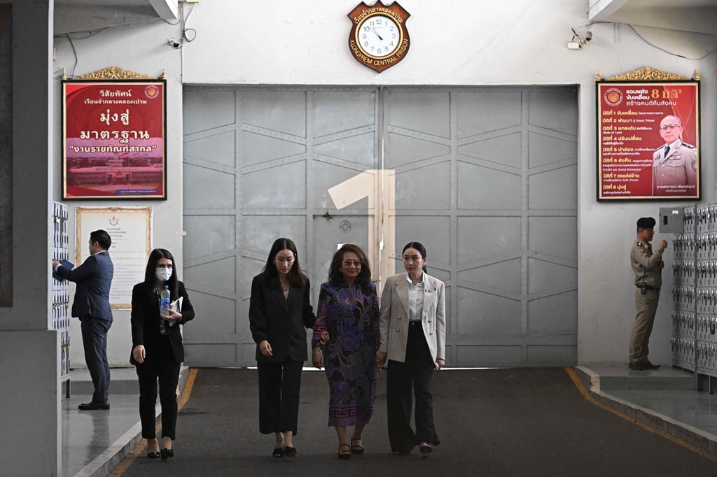 Paetongtarn Shinawatra (right) walks out with her mother Potjaman Na Pombejra (centre) and sister Pintongta Shinawatra Kunakornwong (third from left) after visiting her father, Thailand’s former prime minister Thaksin Shinawatra, at Klong Prem Central Prison in Bangkok on Monday. Photo: AFP