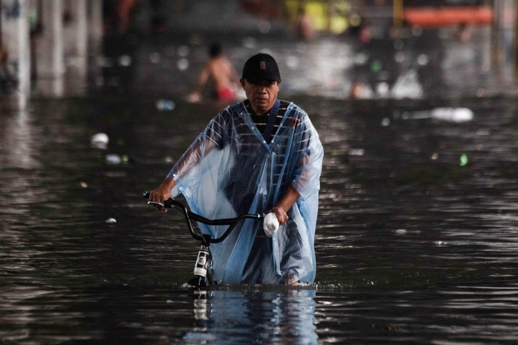 A man wades through a flooded street after heavy rains in Manila in July. Revelations of widespread irregularities in the Philippines’ flood control programme have triggered public fury. Photo: AFP