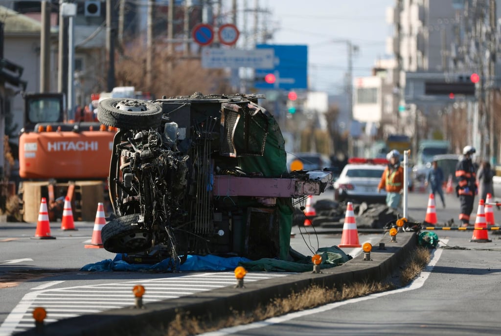 The truck pulled out from a sinkhole is seen at the scene without its driver’s cabin, in Yashio, Japan’s Saitama prefecture, on January 31. Photo: EPA-EFE