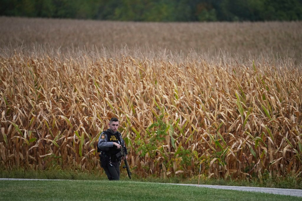 A state police trooper patrols a road after multiple police officers were shot and killed on Wednesday in North Codorus, Pennsylvania. Photo: AP A state police trooper patrols a road after multiple police officers were shot and killed on Wednesday in North Codorus, Pennsylvania. Photo: AP