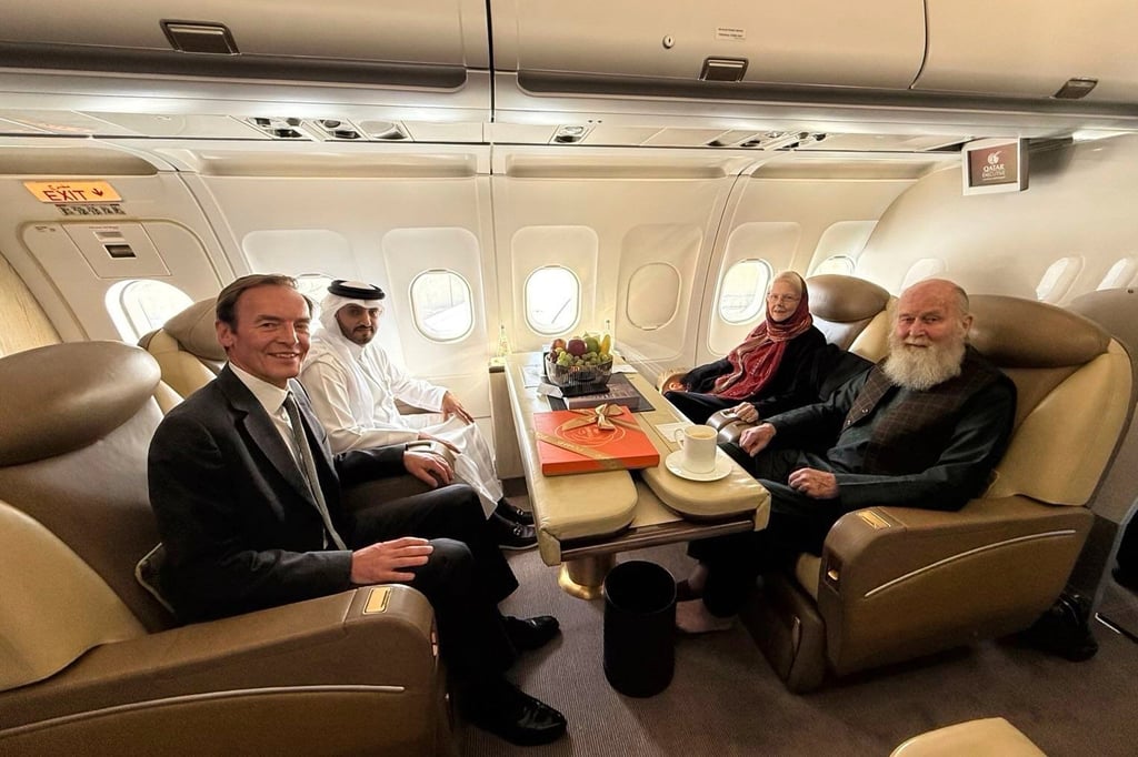 Qatari and British diplomats (left) and the released British couple, Barbie and Peter Reynolds, aboard a plane before departing to Qatar from Kabul, Afghanistan on Friday. Photo: via AP