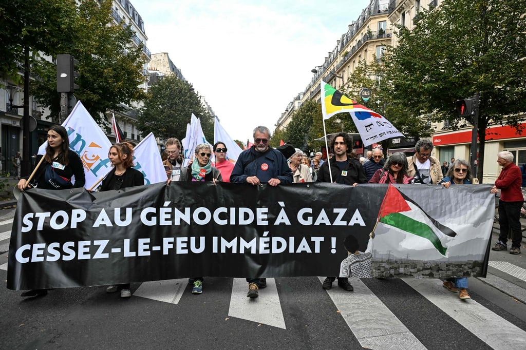Protesters hold a banner reading ‘Stop the genocide in Gaza. Immediate ceasefire!’ as they take part in a march asking for the ‘recognition of the State of Palestine and the end of the genocide,’ in Paris, France, on Sunday. Photo: AFP