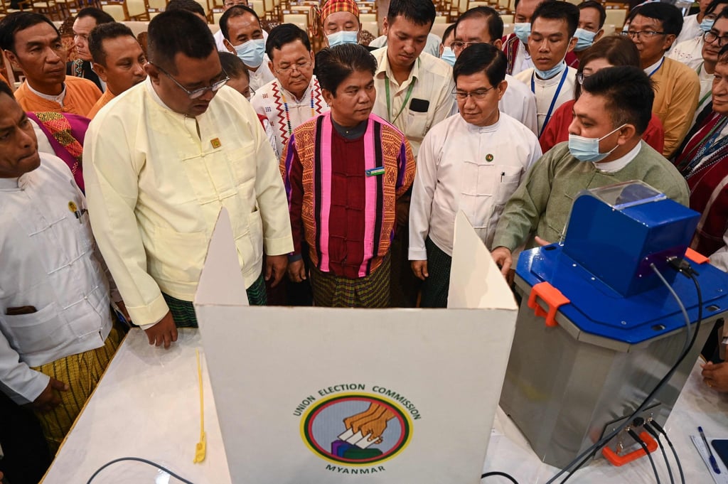 Members of Myanmar’s Union Election Commission gather in Yangon in 2023 to observe voting machines to be used in future elections.