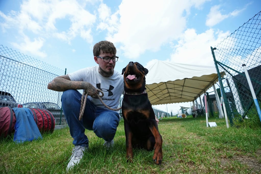 Car sales worker Dario Chiassarini accompanies his Rottweiler puppy Athena at Dog Relais. Photo: AP