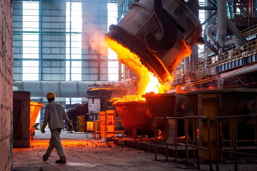 A worker walks past molten steel at a steel factory in China’s eastern Jiangsu province. The Chinese steel industry is plagued by overproduction and weak demand. Photo: AFP