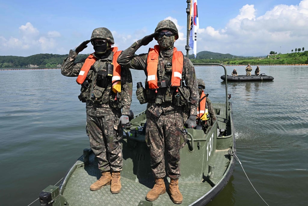South Korean soldiers salute on a boat connected to a floating bridge during a South Korea-US joint river-crossing drill as part of the annual Ulchi Freedom Shield military exercise in Yeoju on August 27. Photo: AFP