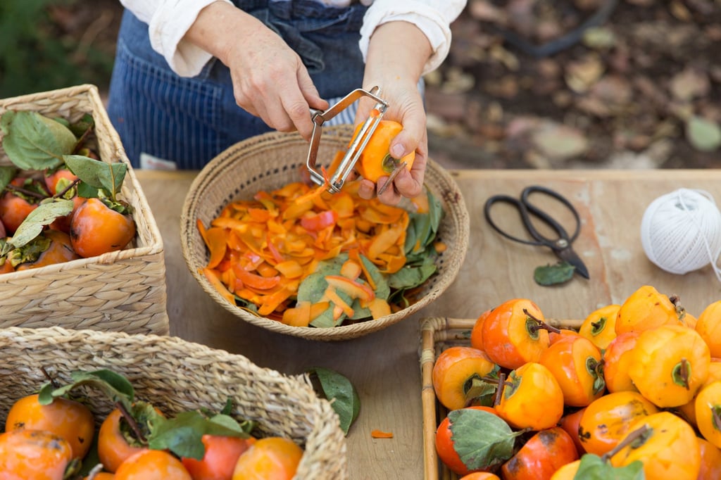 Peeling Hachiya persimmons in preparation for hoshigaki. Photo: Rick Poon Peeling Hachiya persimmons in preparation for hoshigaki. Photo: Rick Poon