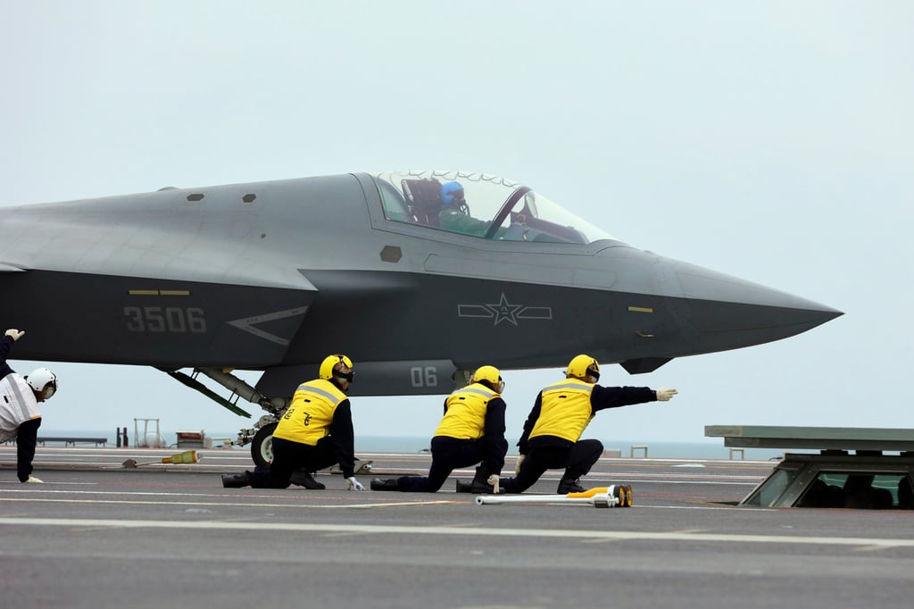 In another undated photo released on Tuesday by Xinhua, crew members signal to the pilot of a J-35 stealth fighter jet for a take-off on the flight deck of the Fujian at an undisclosed location. Photo: Xinhua via AP