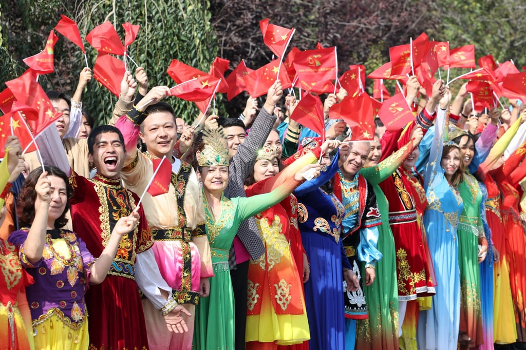 People of various ethnic groups line the streets of Urumqi to welcome the delegation from Beijing headed by President Xi Jinping. Photo: Xinhua
