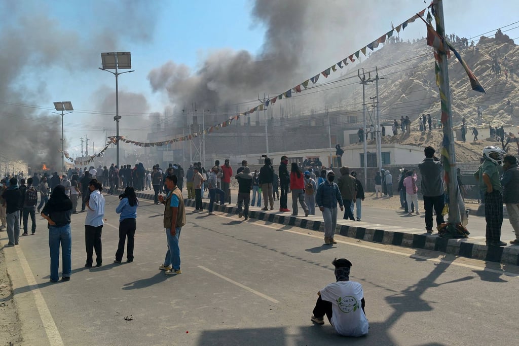 Smoke rises from a police vehicle that was torched by the demonstrators near the Bharatiya Janata Party (BJP) office in Leh on Wednesday. Photo: AFP