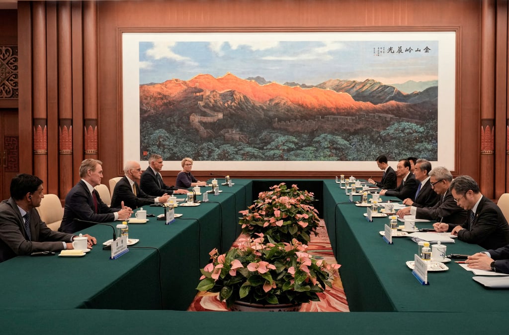 Chinese Foreign Minister Wang Yi (centre right) speaks with US House representatives in Beijing on Tuesday. Photo: Pool via Reuters