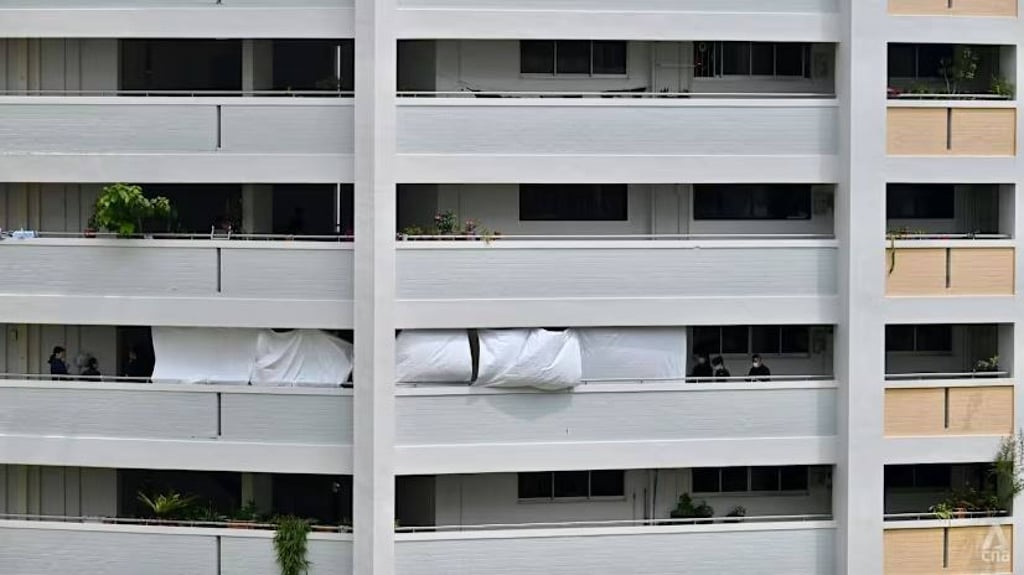 Police officers on the sixth floor of Block 323 Yishun Central in Singapore on Wednesday. Photo: CNA