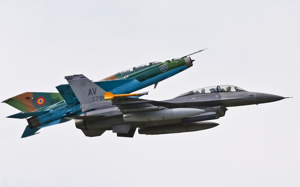 A Russian made MiG 21 fighter jet manoeuvres next to a US Air Force F-16 during a military exercise in Romania in 2014. Photo: AP