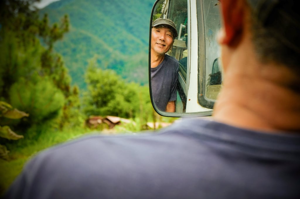Asha Kama Wangdi in front of the bus he converted into a residence in his art village in Kabjisa. Photo: Bibek Bhandari