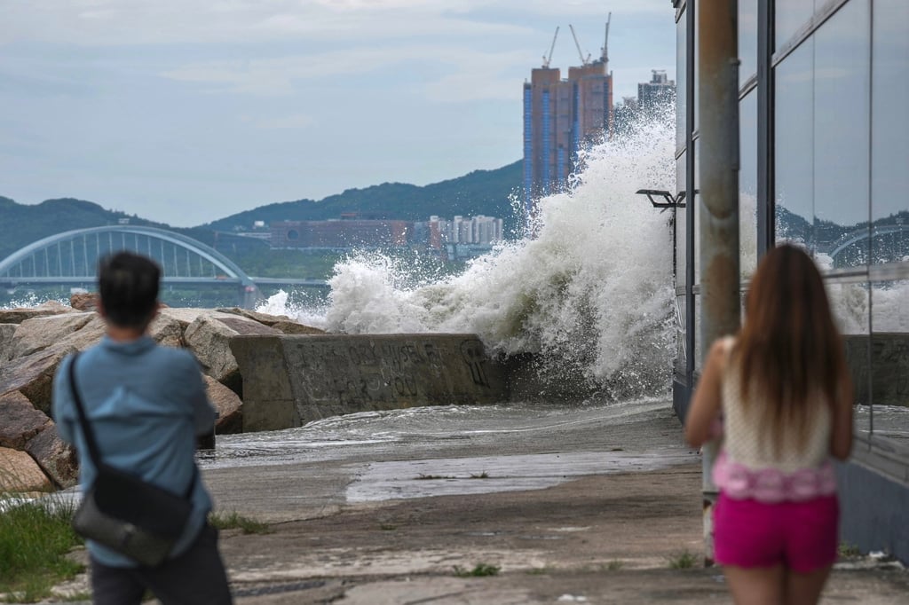 Residents watch as waves pound the Siu Sai Wan waterfront during Super Typhoon Ragasa. Photo: Karma Lo