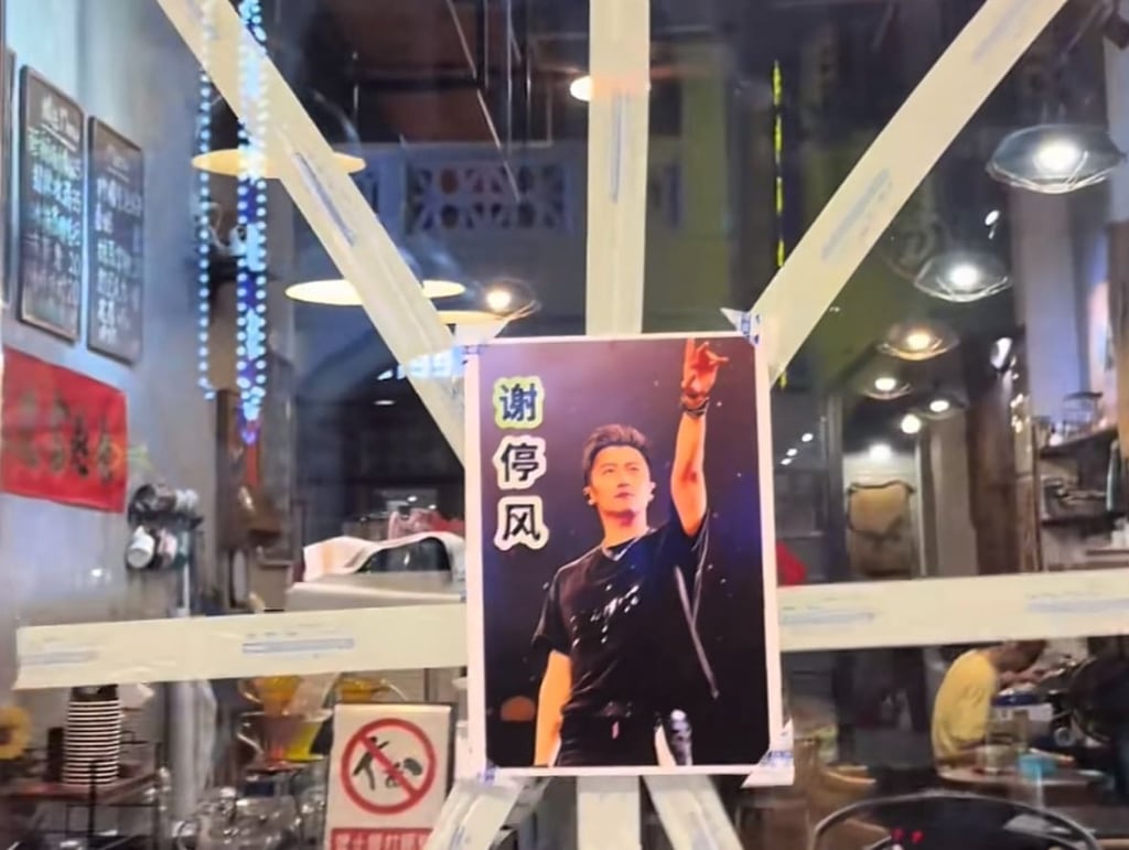 Pointing the way: Tse’s image is pasted on a window ahead of the approaching storm. Photo: Handout