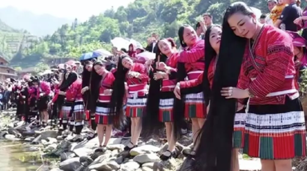 Women from the Red Yao ethnic group groom themselves on a riverbank. Photo: Handout
