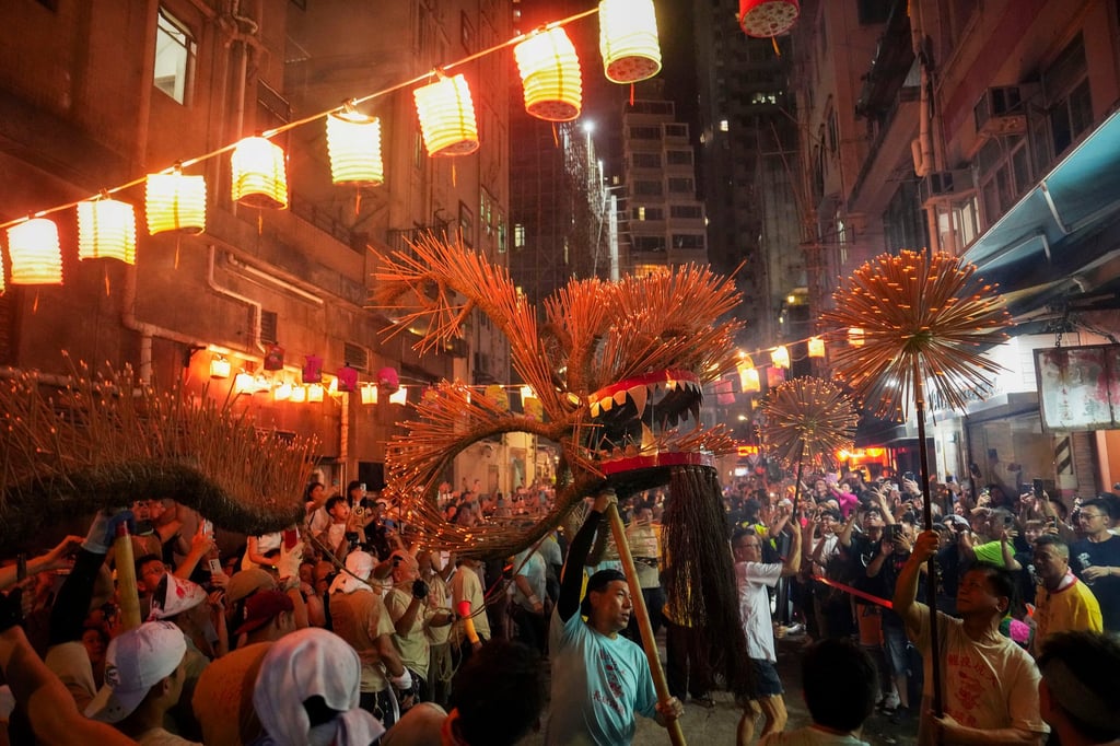 The dragon is carried by dancers under burning incense sticks. Photo: Elson Li