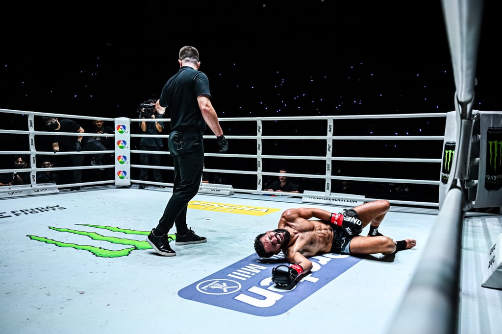 Ilias Ennahachi rolls around in agony after being struck in the groin by Nabil Anane. Photo: ONE Championship