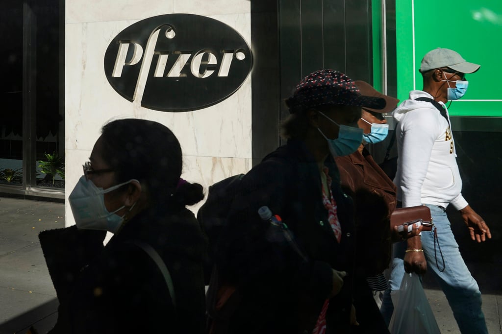 People walk past Pfizer’s headquarters in New York. Pfizer is among drug makers which have facilities in Singapore and the US. Photo: AP