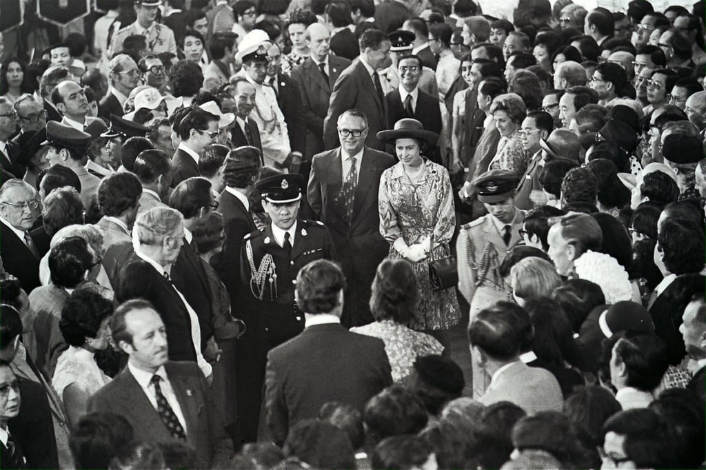 Hong Kong secretary for home affairs Denis Bray accompanies Queen Elizabeth on a tour of Ocean Terminal, Hong Kong, in 1975. Photo: SCMP Archives