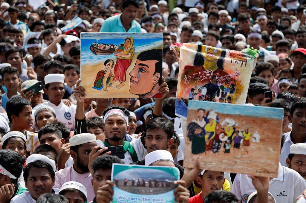 Rohingya refugees hold placards and paintings at a protest rally inside a refugee camp to mark the eighth anniversary of their exodus, in Cox’s Bazar, Bangladesh, on August 25. Photo: Reuters