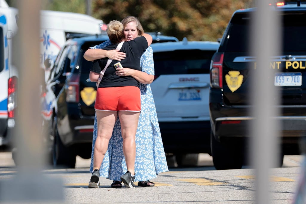 People embrace near the scene of a shooting at a church in Grand Blanc, Michigan on Sunday. Photo: AFP People embrace near the scene of a shooting at a church in Grand Blanc, Michigan on Sunday. Photo: AFP