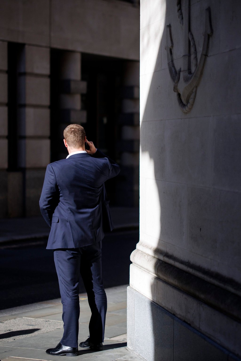 A city worker talks on the phone in London’s financial district on Thursday. Photo: EPA