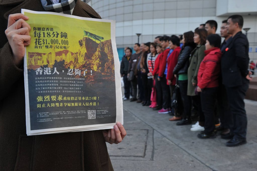 A Hong Kong newspaper with an anti-mainland Chinese advertisement with a picture of a locust looming over the Hong Kong cityscape as mainlanders pose for a picture in the background on February 1, 2012. Photo: AFP