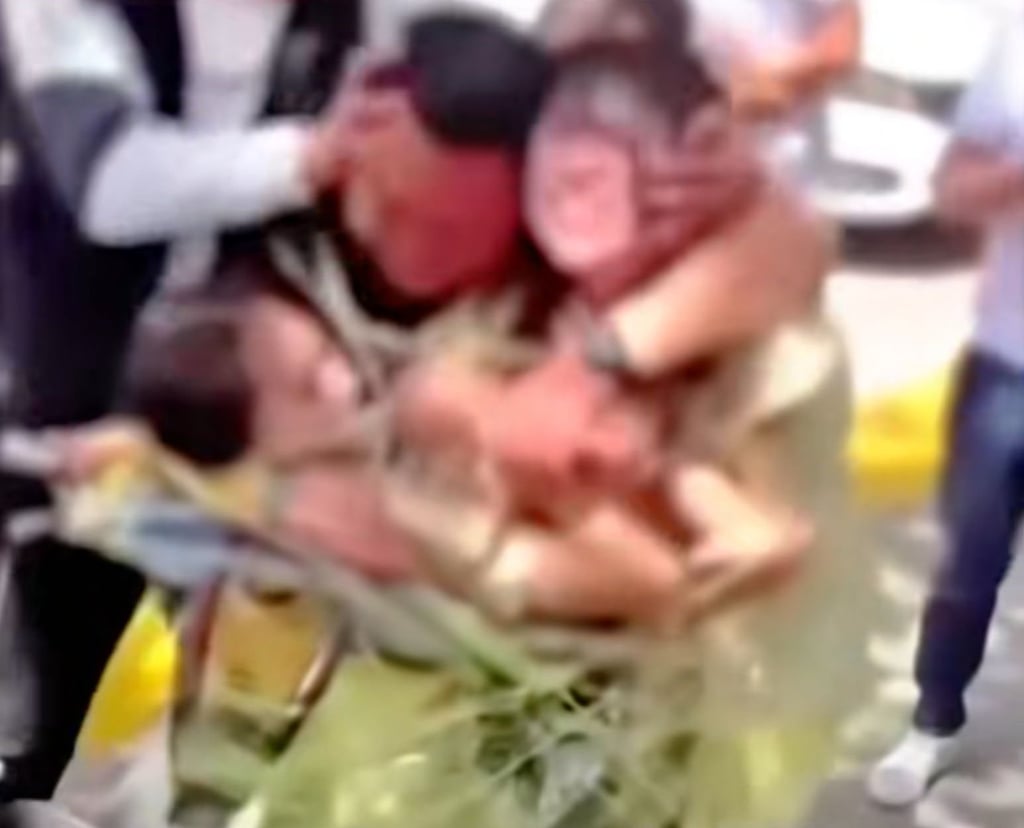In an incident in Shaanxi province, several men taped two women to an electric bike by the roadside, with one man holding their heads down while another kissed them. Photo: Douyin