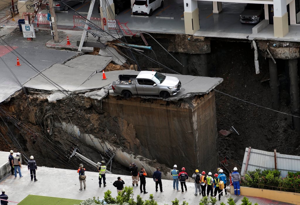 Thai officials inspect a sinkhole in Bangkok on Wednesday. Photo: EPA