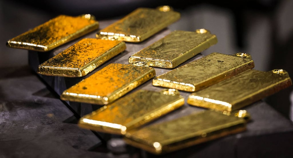Gold bars are removed from casts at a refinery. Photo: AFP