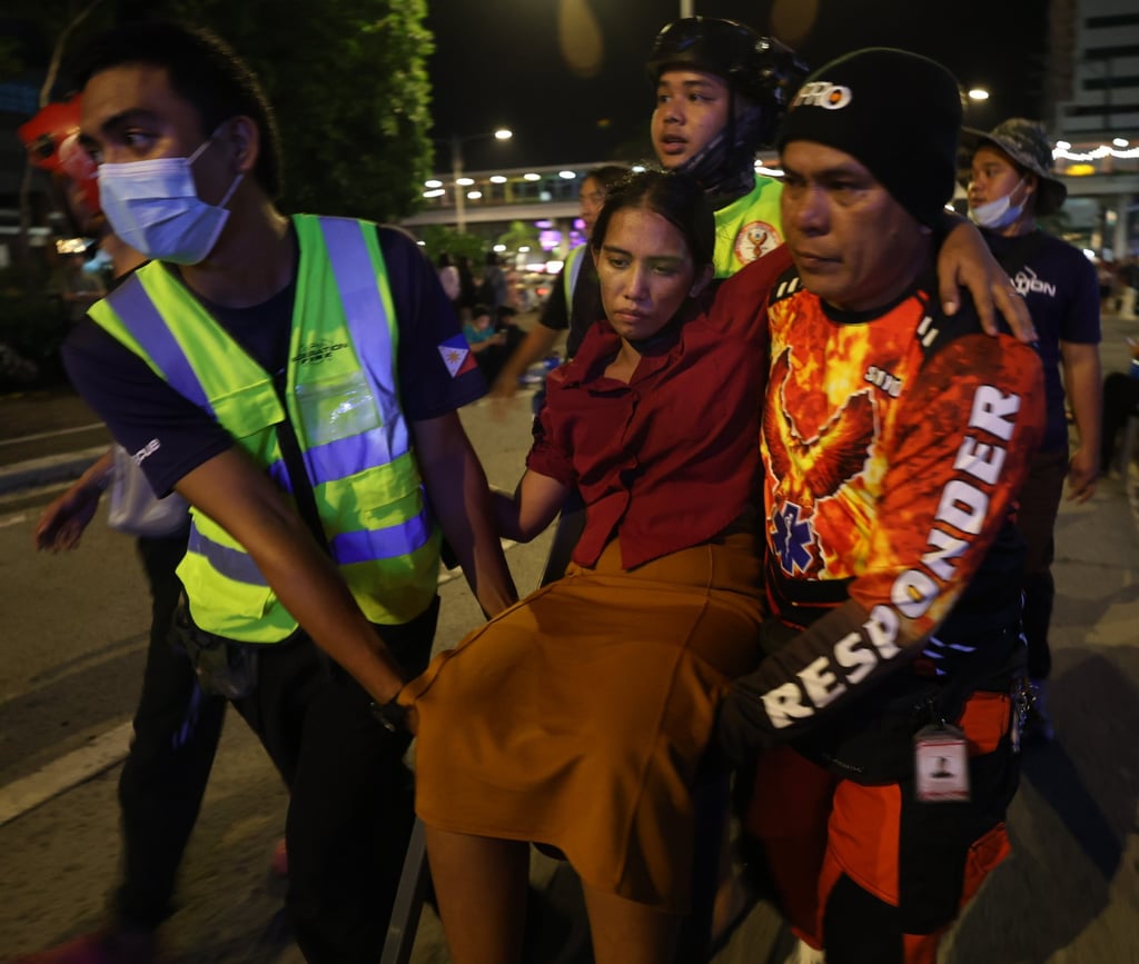 Rescuers carry an injured woman after an earthquake in Ilo-Ilo city in the Philippines, on Tuesday. Photo: EPA