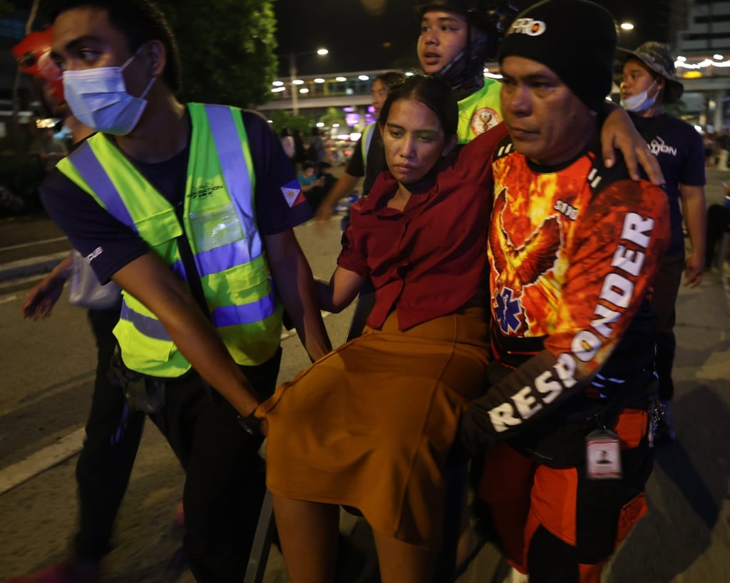 Rescuers carry an injured woman after an earthquake in Ilo-Ilo city in the Philippines on Tuesday. Photo: EPA