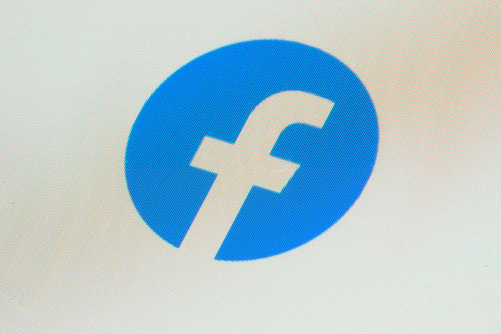 The Facebook app icon is seen on a smartphone. Shortly before its suspension, Malaysiakini reported on a coordinated campaign to amplify positive engagement with Anwar’s official Facebook page. Photo: AP