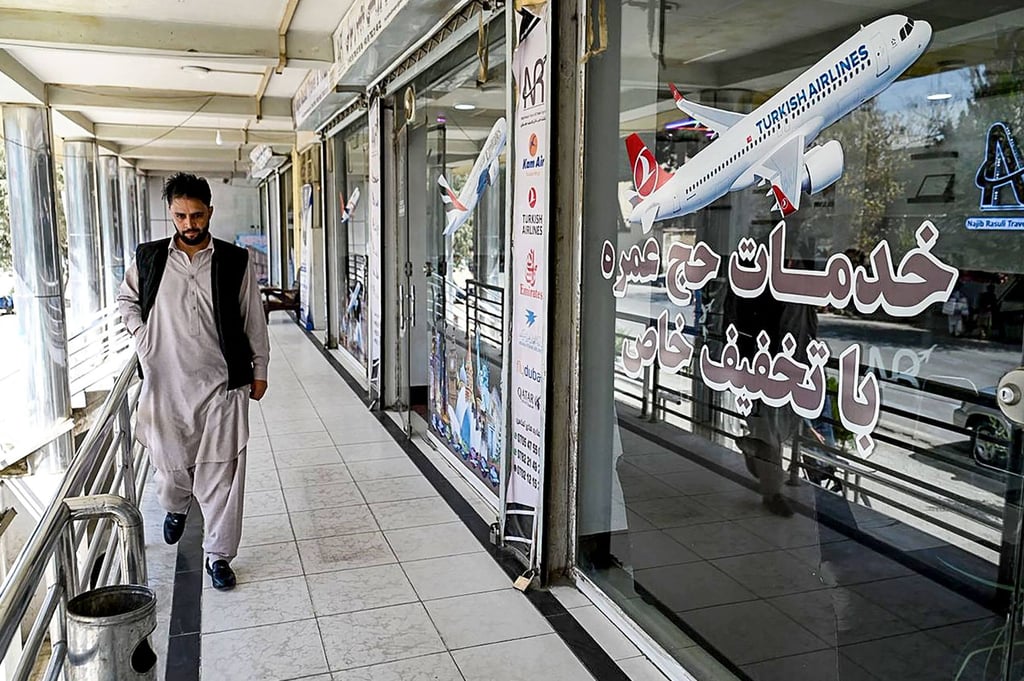 An Afghan employee from a travel agency in Kabul walks past offices amid a nationwide telecoms outage on Tuesday. Photo: AFP An Afghan employee from a travel agency in Kabul walks past offices amid a nationwide telecoms outage on Tuesday. Photo: AFP