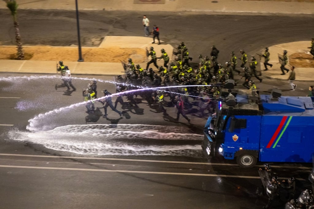 Security forces disperse a gathering in Sale, Morocco. Photo: EPA