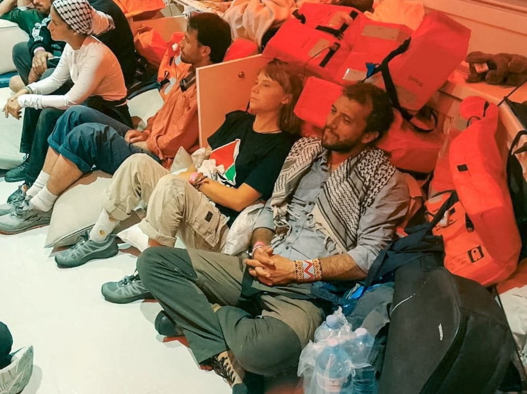 Swedish activist Greta Thunberg and Brazilian activist Thiago Avila sit in a vessel after Israel intercepted some of the vessels of the Global Sumud Flotilla. Photo: Israel Foreign Ministry/Reuters