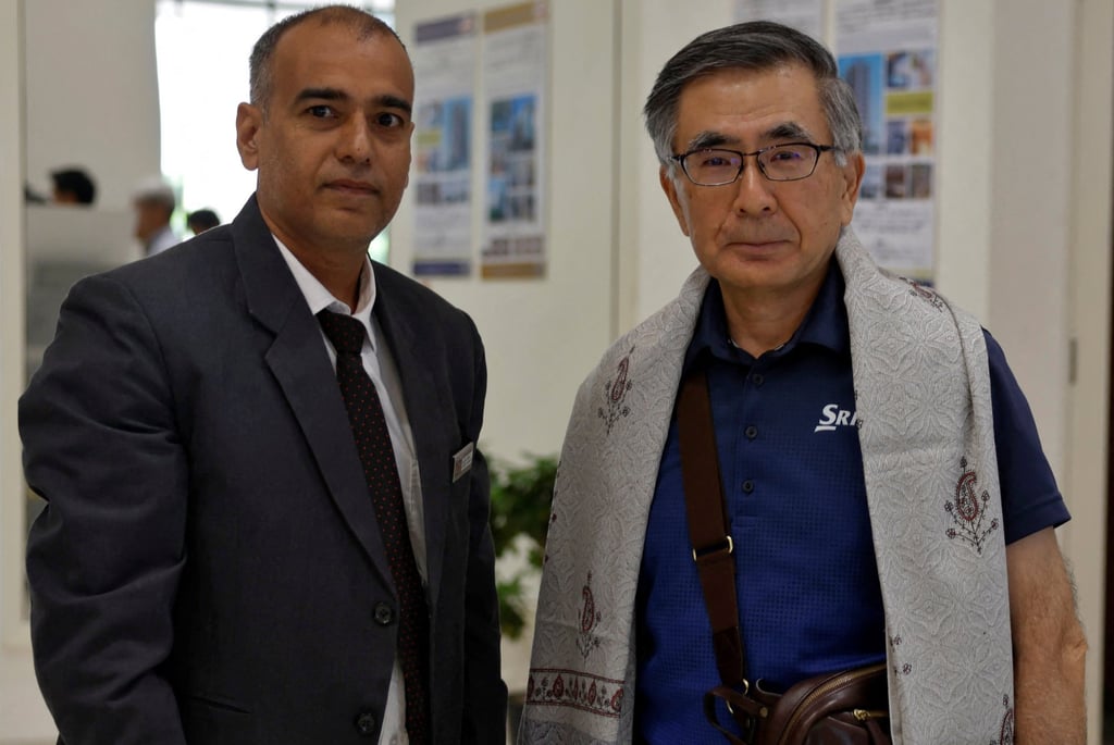 AJU Imperial General Manager Rajesh Kumar (left) poses for a picture with Toshihiro Suzuki, Suzuki Motor’s chairman and president. Photo: Reuters