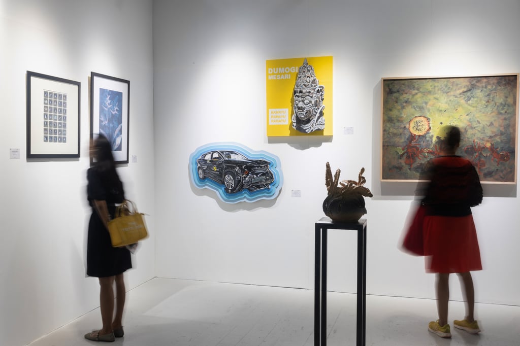 People look at work on display at the contemporary art fair Art & Bali.