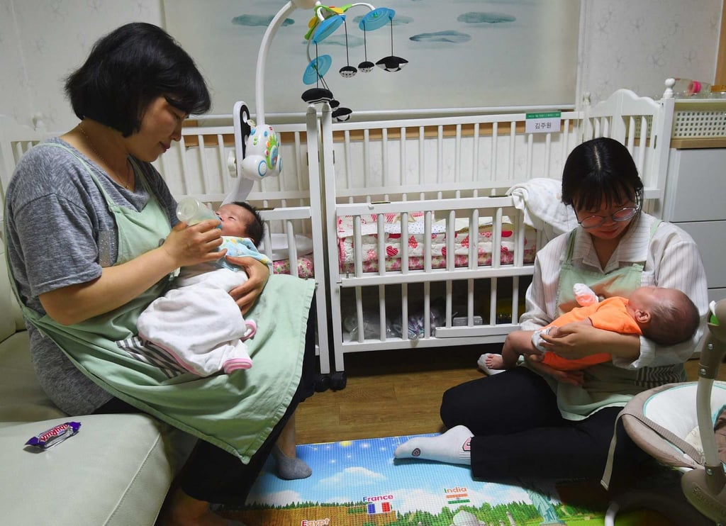 Social workers look after babies at the Jusarang Community Church in southern Seoul. Photo: AFP Social workers look after babies at the Jusarang Community Church in southern Seoul. Photo: AFP