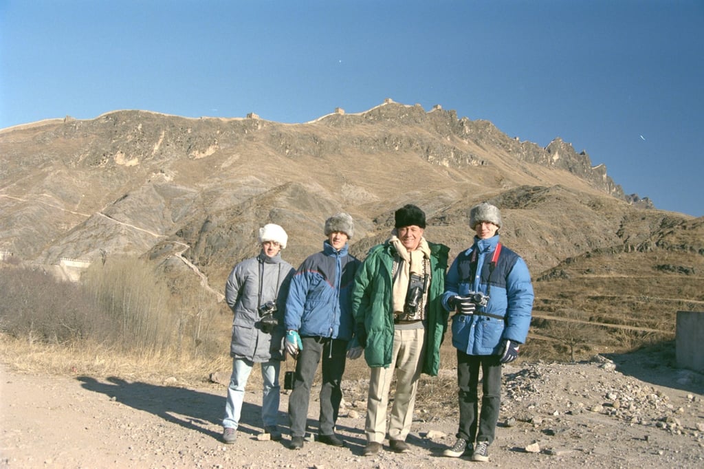 Donald with his father, brother Alexander and a family friend at the Great Wall of China in 1990. Photo: courtesy Angus Donald Donald with his father, brother Alexander and a family friend at the Great Wall of China in 1990. Photo: courtesy Angus Donald