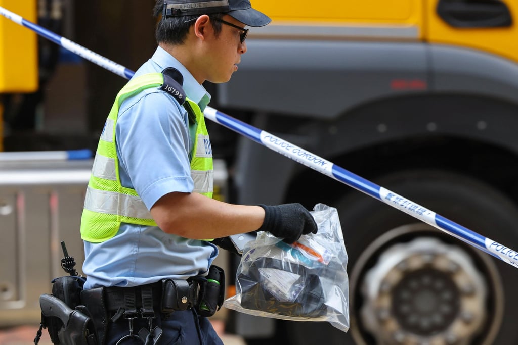 An officer gathers evidence at the scene. Photo: Karma Lo