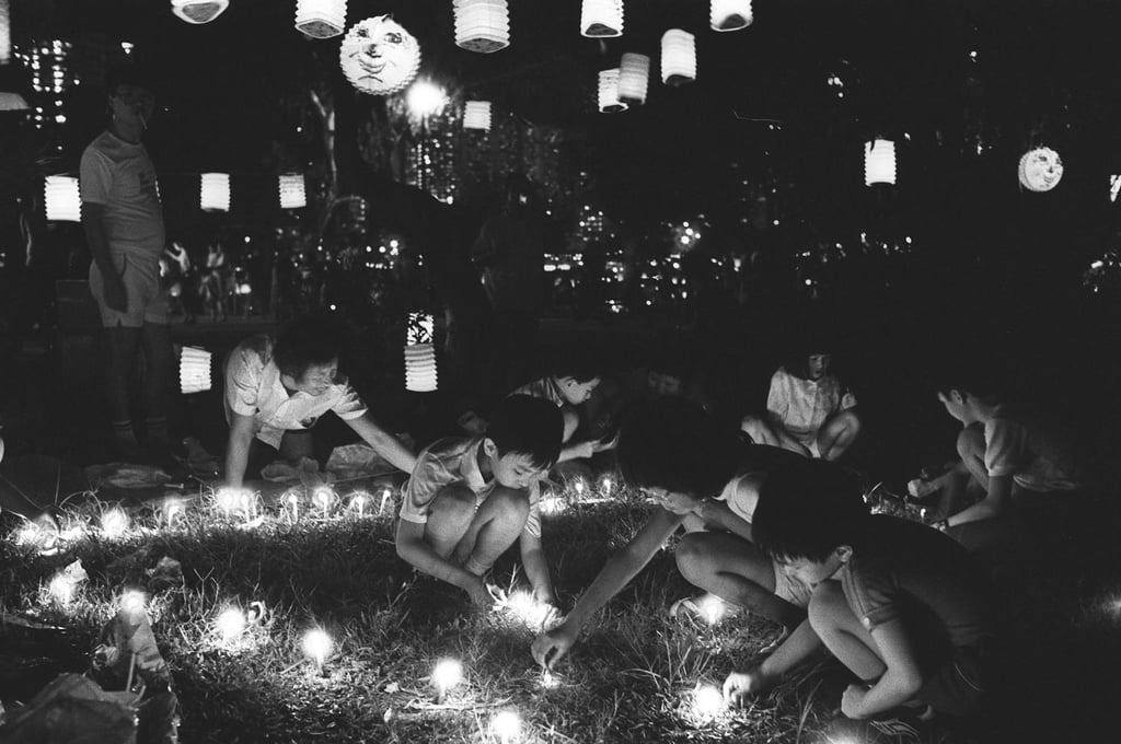 Children light candles during the 1984 festivities. Melting or burning wax has since been banned in the city, and candles must be placed in non-flammable containers. Photo: SCMP Archives Children light candles during the 1984 festivities. Melting or burning wax has since been banned in the city, and candles must be placed in non-flammable containers. Photo: SCMP Archives