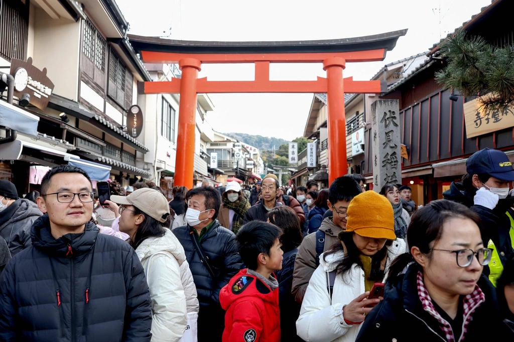 Tourists crowd a street near the Fushimi Inari Shrine in Kyoto earlier this year. Photo: AFP