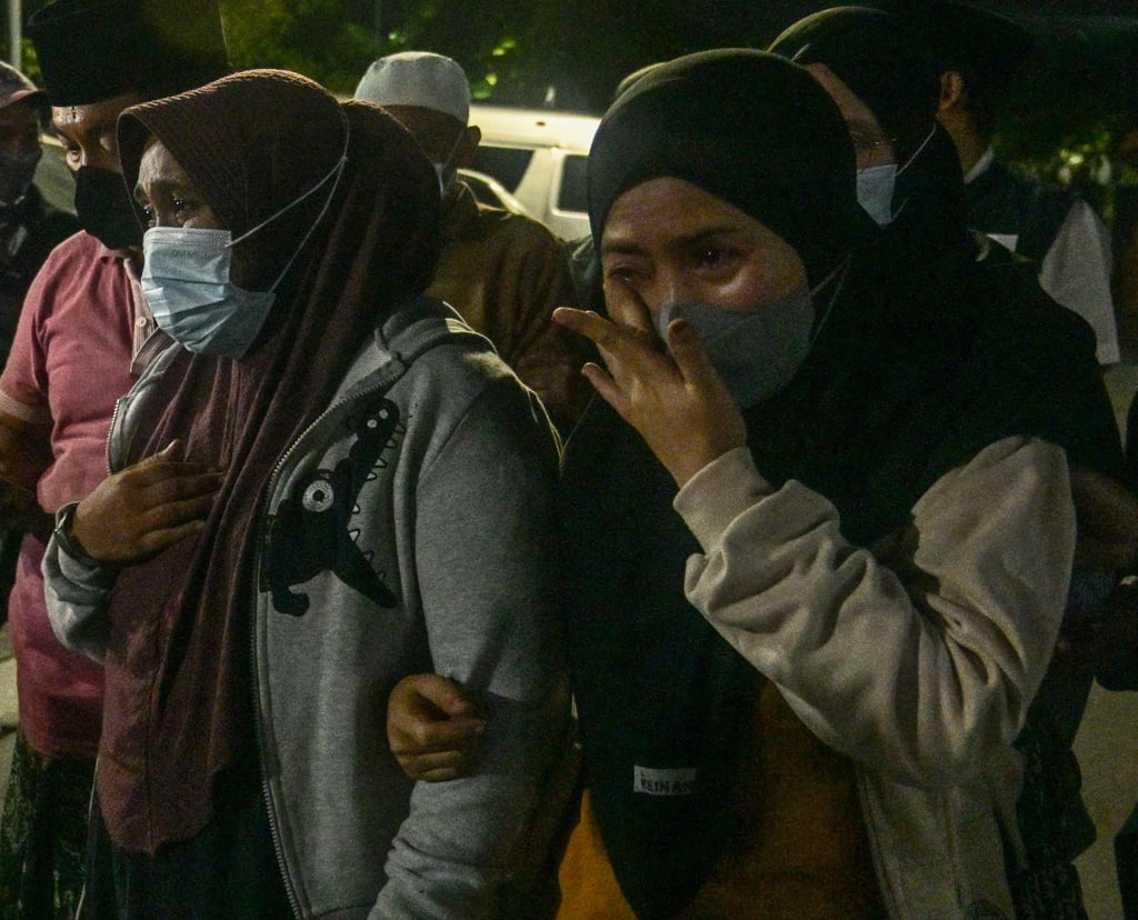 Relatives of a missing student cry on seeing their childs body in the morgue at Bhayangkara Hospital in Surabaya, East Java, on Sunday. Photo: AFP