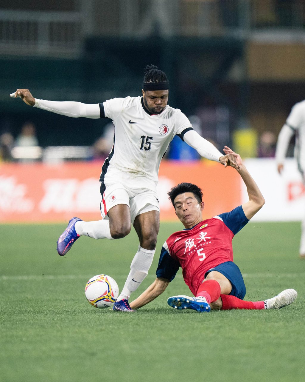 Awal tries to evade China defender Hu Ruibao during the summer East Asian finals. Photo: HKFA