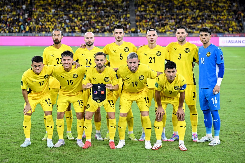 Malaysia’s players pose for a team photo before the start of the Asian Cup qualifier match against Vietnam on June 10. Photo: AFP
