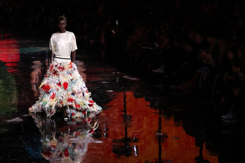 A simple white T-shirt in silk with a feather skirt closed the show. Photo: AFP